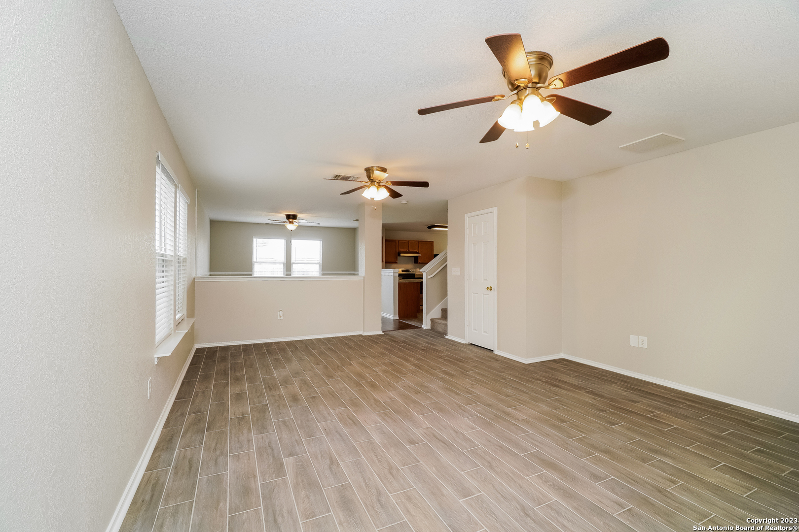9620 Copper Sands Converse, TX 78109 - Photo 4 of 17 wooden floor in an empty room with a window