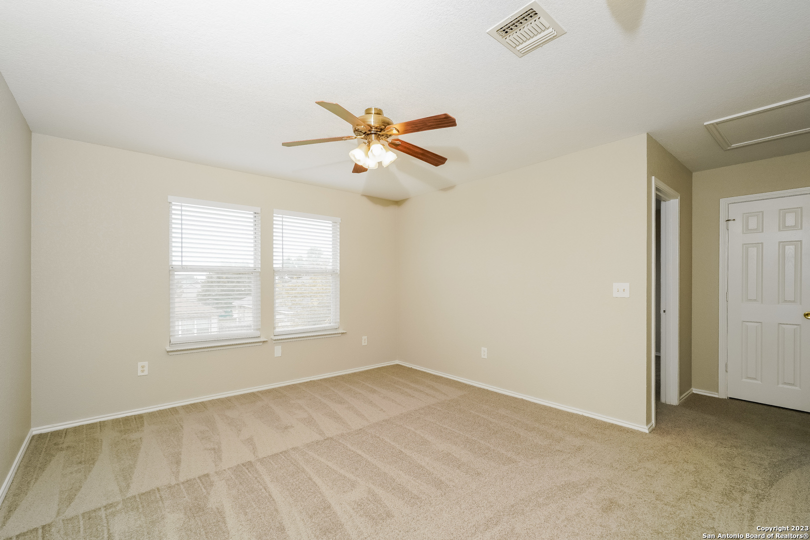 9620 Copper Sands Converse, TX 78109 - Photo 8 of 17 an empty room with chandelier fan and windows