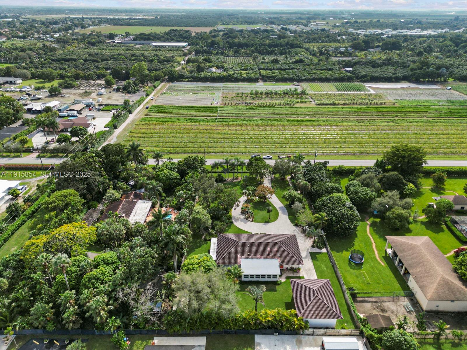 19425 Southwest 312th Street Homestead, FL 33030 - Photo 5 of 60 an aerial view of a house with a garden and lake view