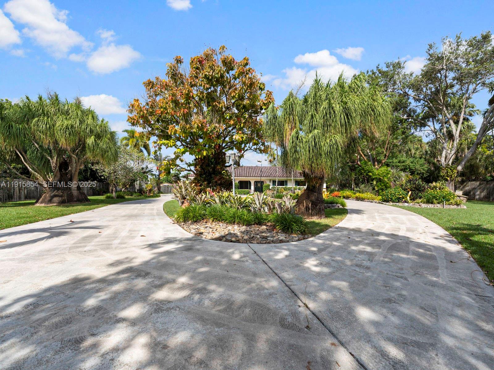 19425 Southwest 312th Street Homestead, FL 33030 - Photo 9 of 60 a view of a street with a house in the background