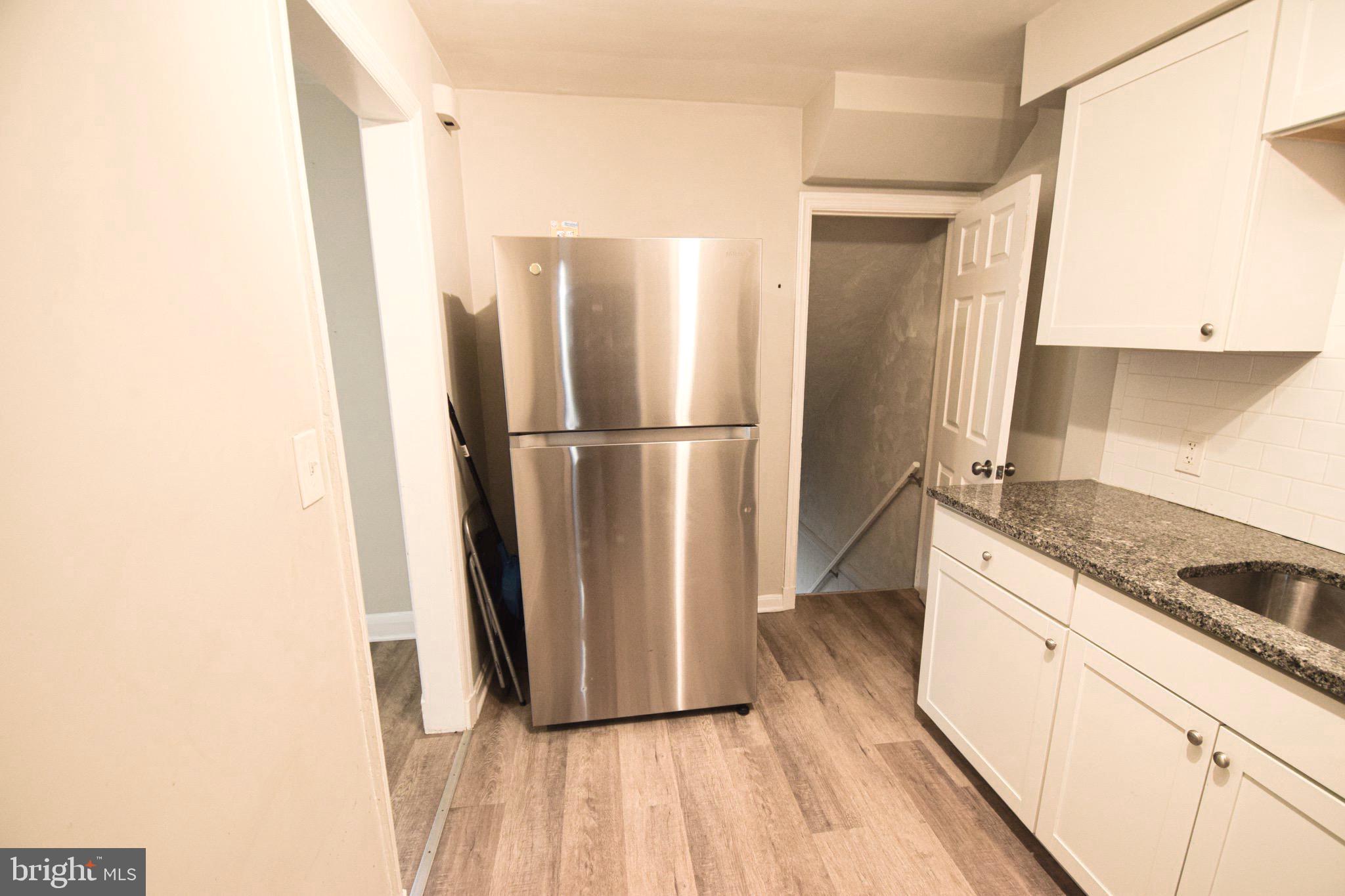 6419 Marietta Avenue Baltimore, MD 21214 - Photo 12 of 38 a kitchen with granite countertop a refrigerator and a stove