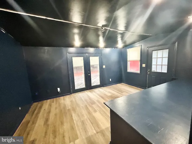 a view of an empty room with windows and stairs