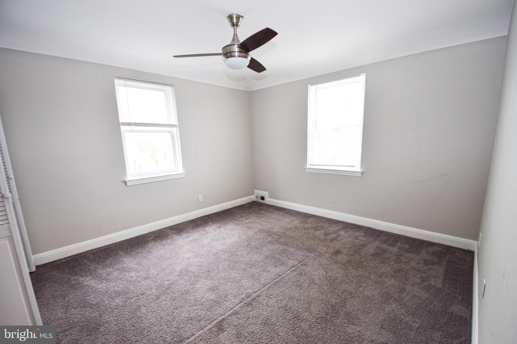 6419 Marietta Avenue Baltimore, MD 21214 - Photo 16 of 38 an empty room with windows and fan