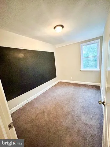 a view of an empty room and closet area