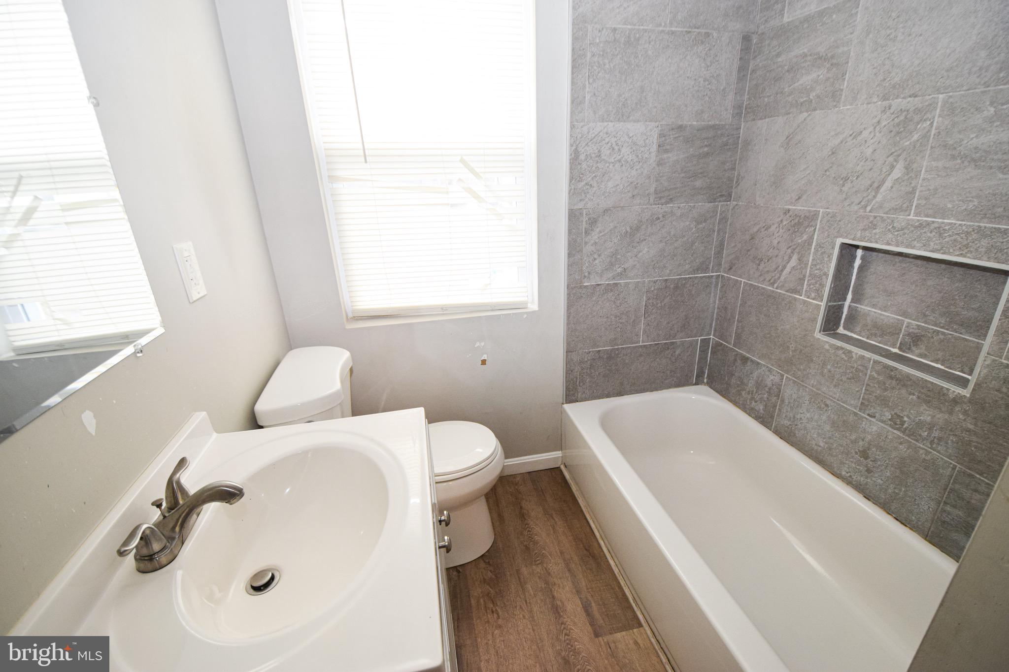 6419 Marietta Avenue Baltimore, MD 21214 - Photo 20 of 38 a bathroom with a sink a toilet and shower