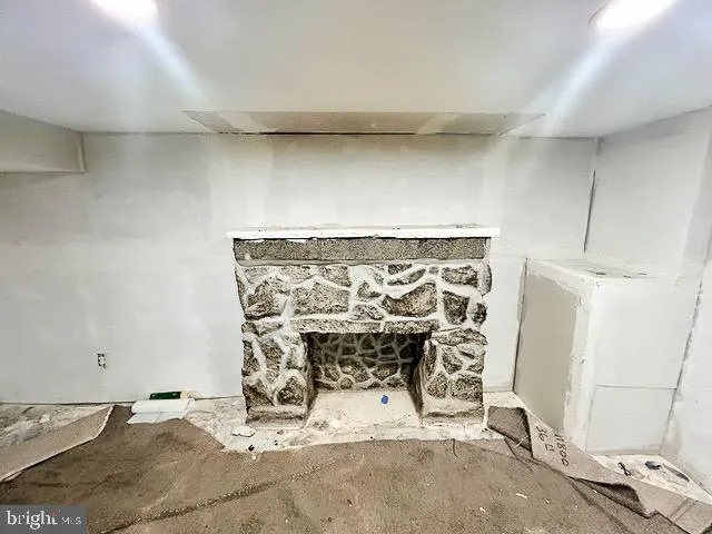 a view of an empty room with a fireplace
