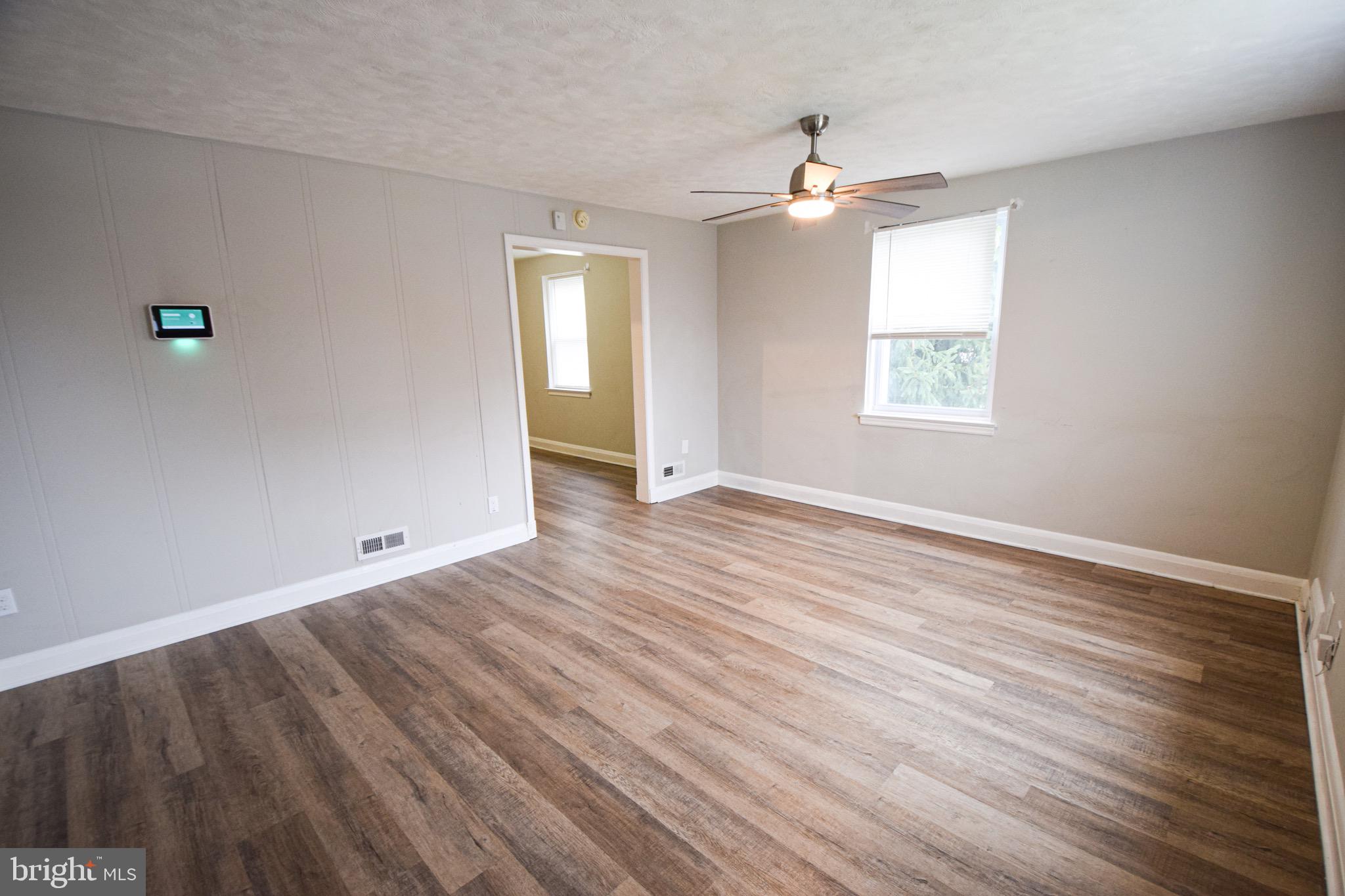 6419 Marietta Avenue Baltimore, MD 21214 - Photo 3 of 38 wooden floor in an empty room with a window