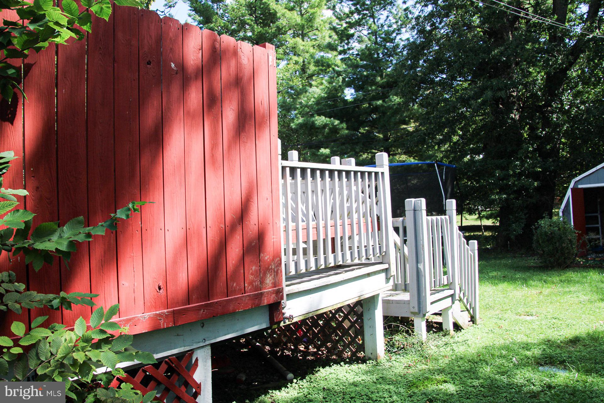 6419 Marietta Avenue Baltimore, MD 21214 - Photo 31 of 38 a view of a small yard with wooden fence and plants
