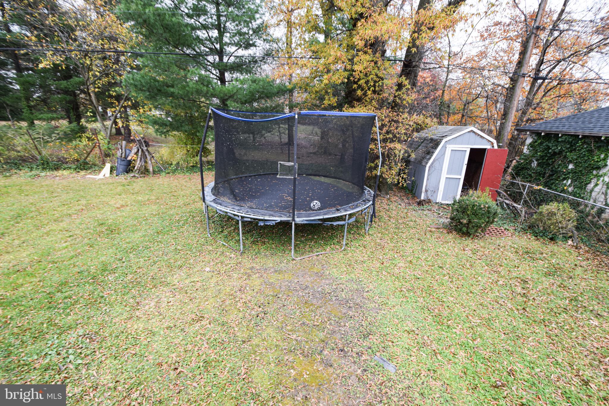 6419 Marietta Avenue Baltimore, MD 21214 - Photo 32 of 38 a view of a backyard with plants and brick wall