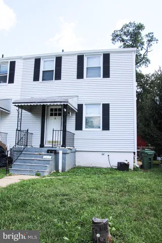 a view of a small yard with wooden fence and plants