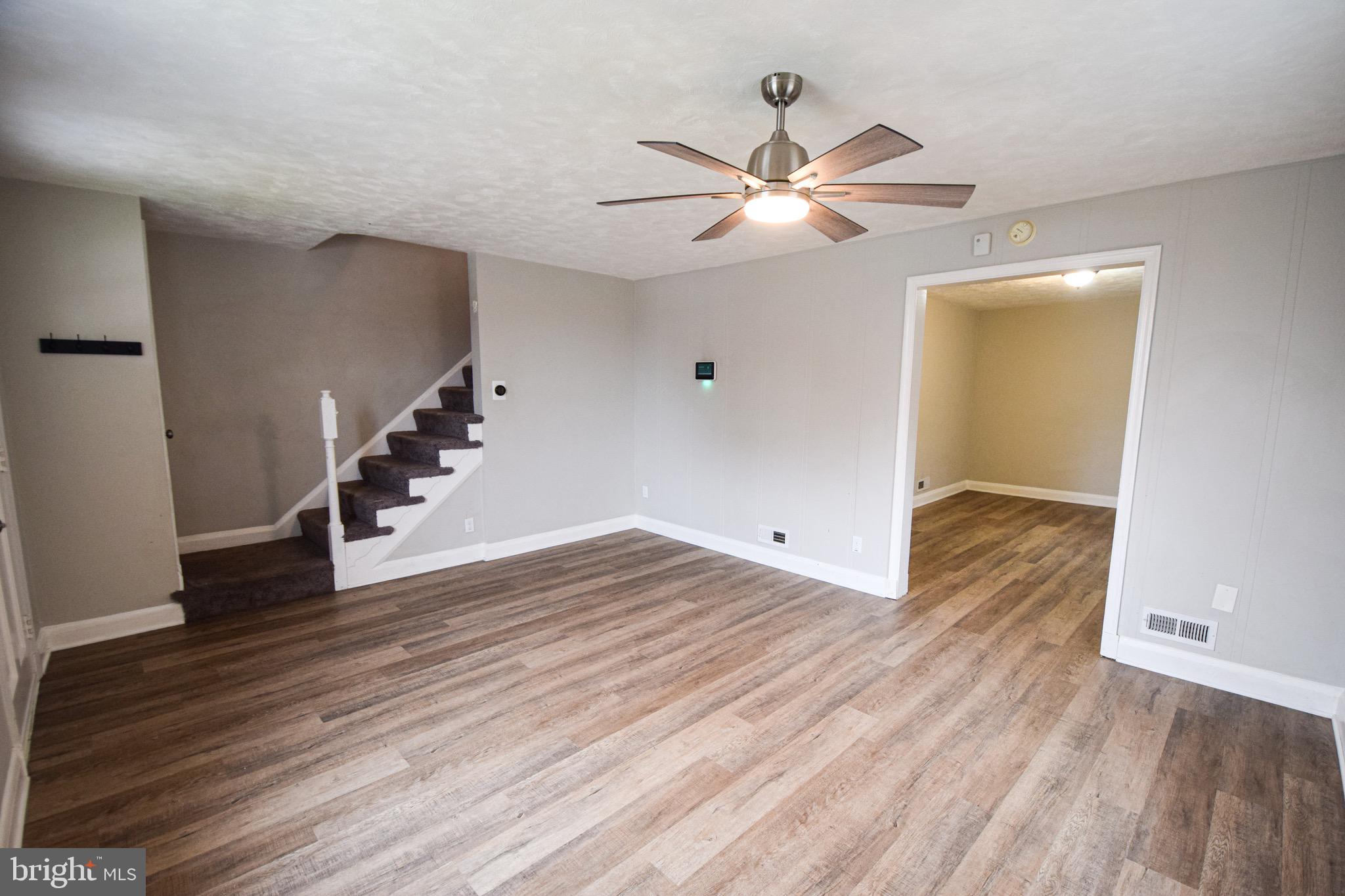 6419 Marietta Avenue Baltimore, MD 21214 - Photo 4 of 38 a view of empty room with wooden floor and ceiling fan
