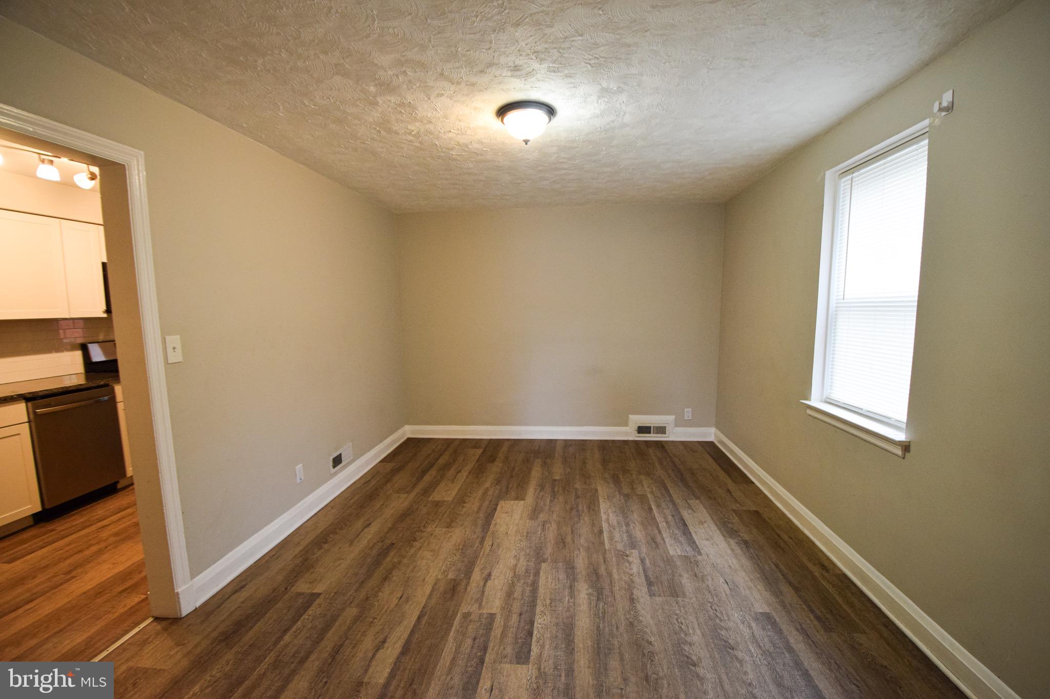 6419 Marietta Avenue Baltimore, MD 21214 - Photo 6 of 38 a view of an empty room and wooden floor