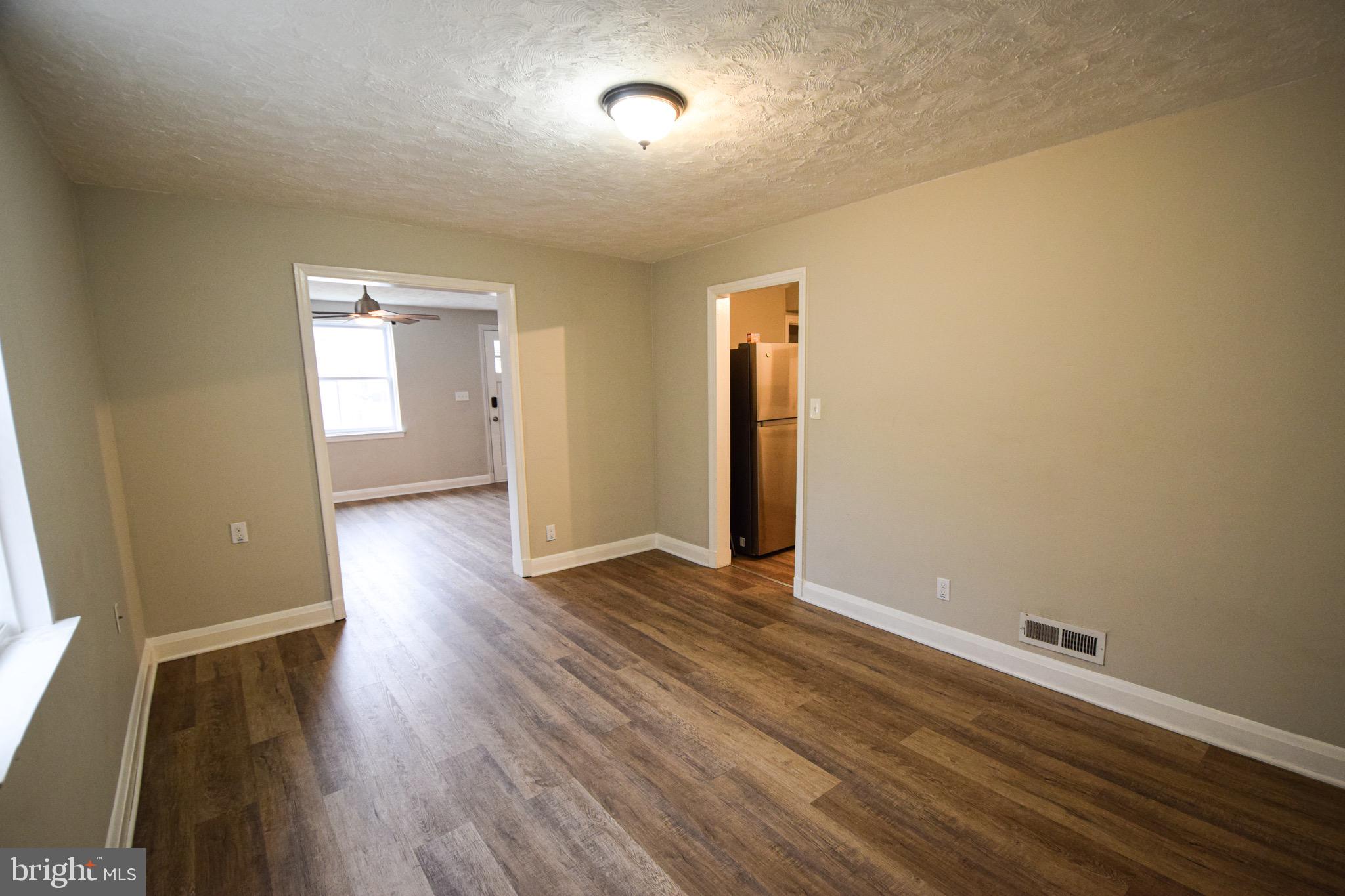 6419 Marietta Avenue Baltimore, MD 21214 - Photo 7 of 38 a view of an empty room with wooden floor