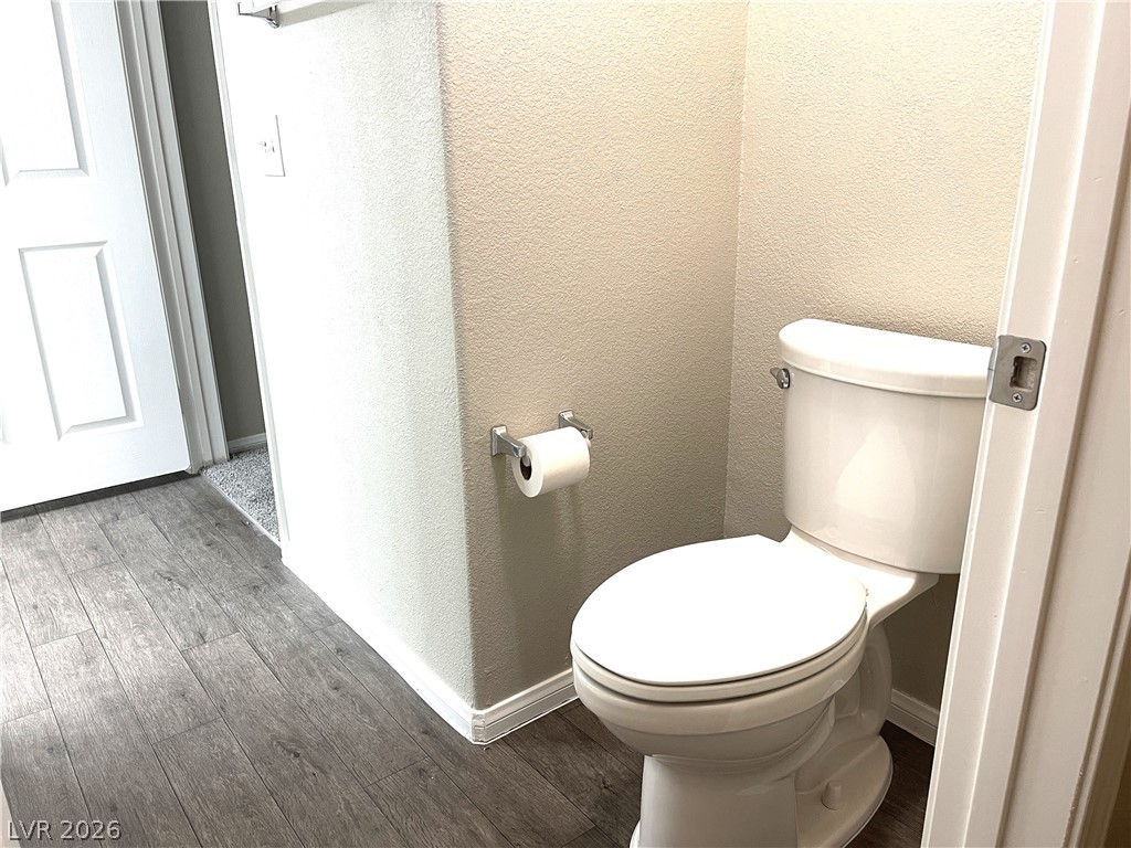10001 Peace Way, Unit 1327 Las Vegas, NV 89147 - Photo 17 of 21 A well-maintained commode area features wood flooring.