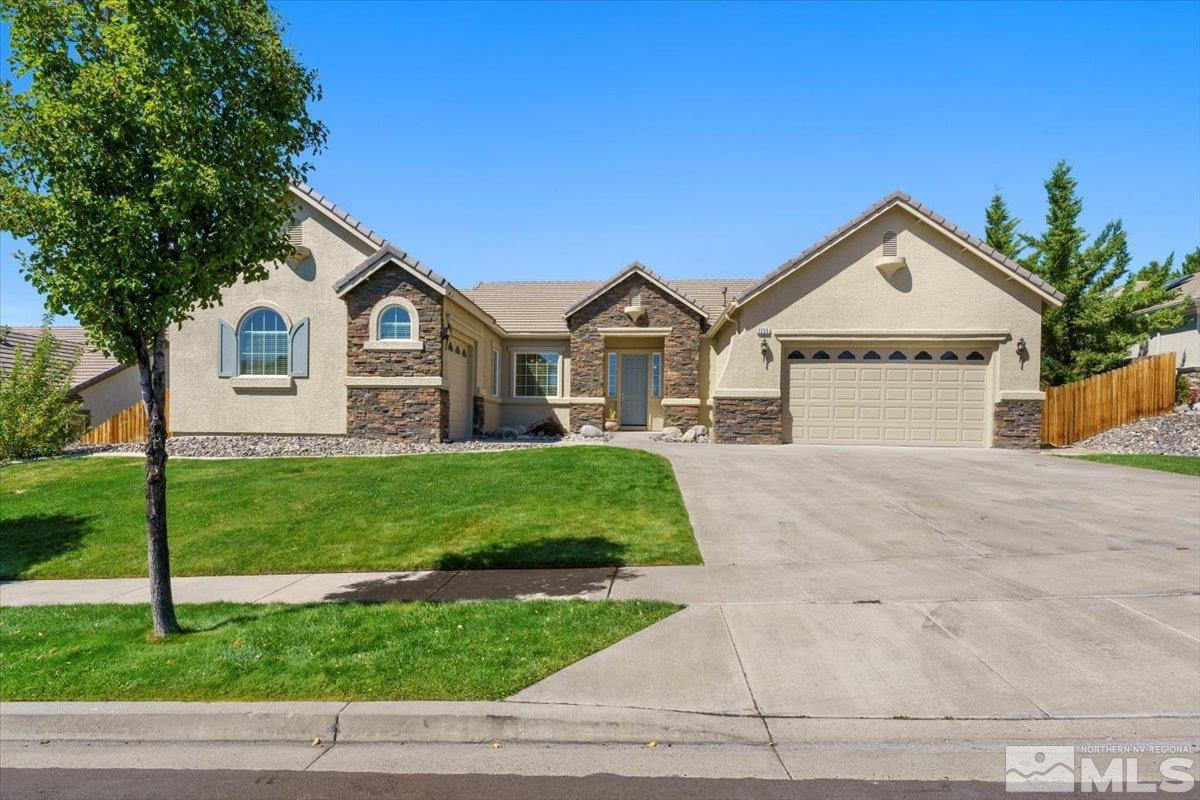 a front view of a house with a yard and garage