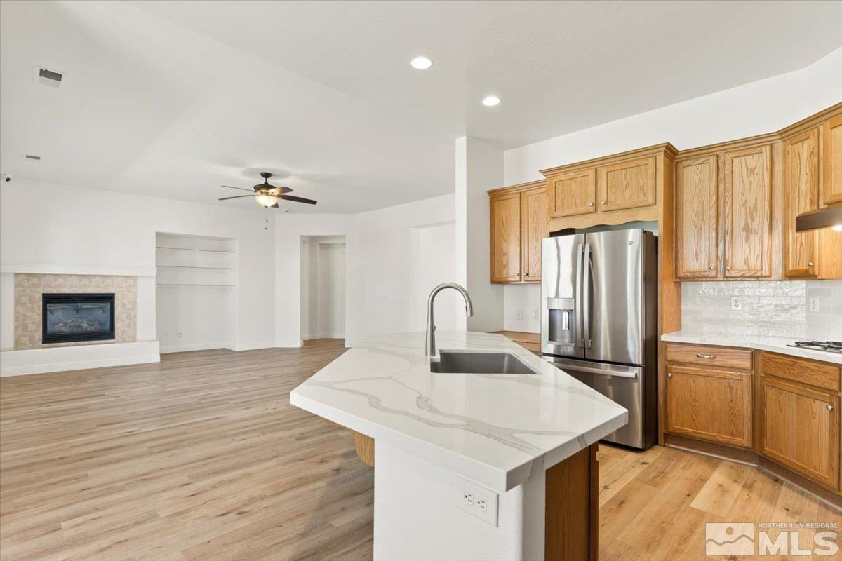3259 Diamond Ridge Drive Reno, NV 89523 - Photo 14 of 40 a kitchen with stainless steel appliances granite countertop a refrigerator a stove and a sink with wooden floor