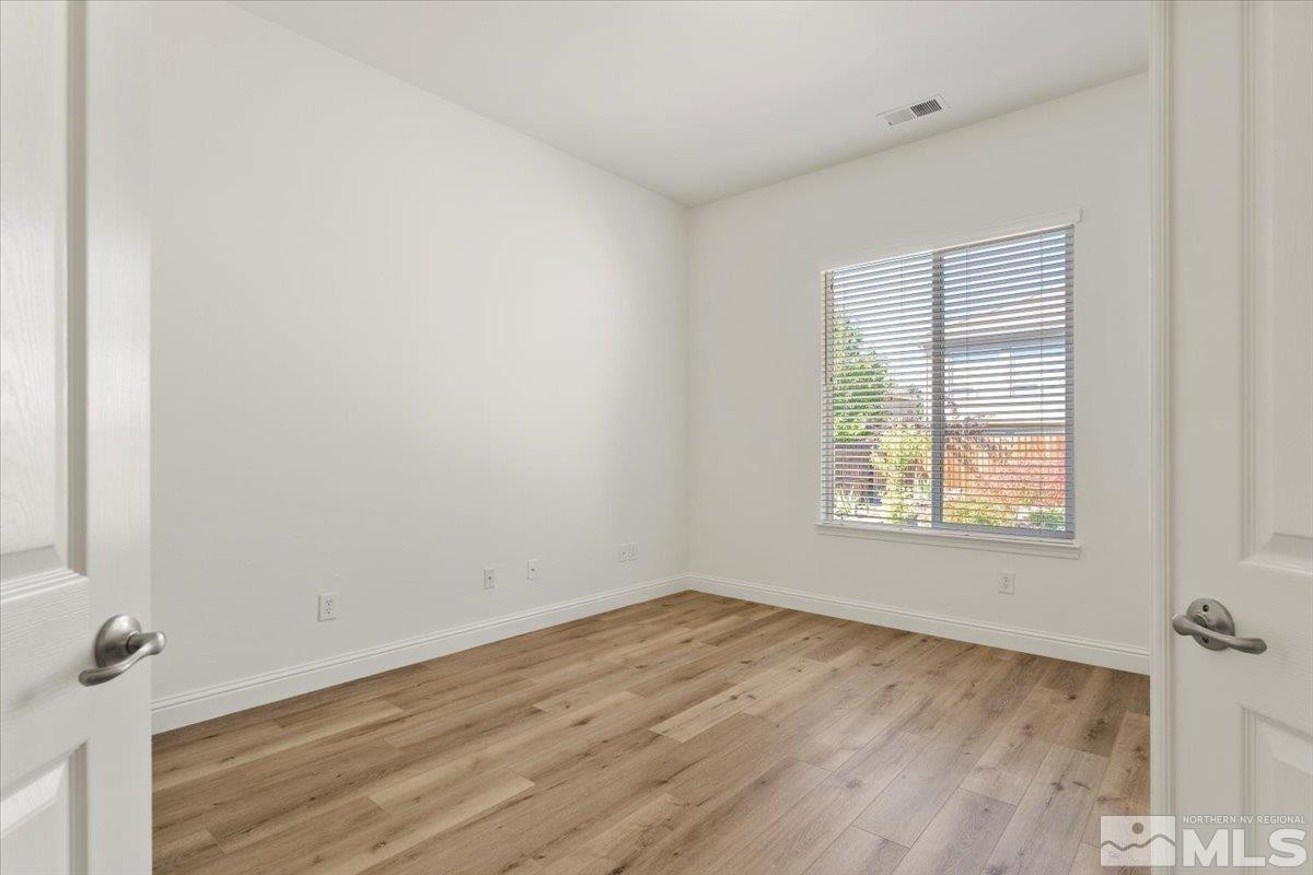 3259 Diamond Ridge Drive Reno, NV 89523 - Photo 21 of 40 an empty room with wooden floor and windows