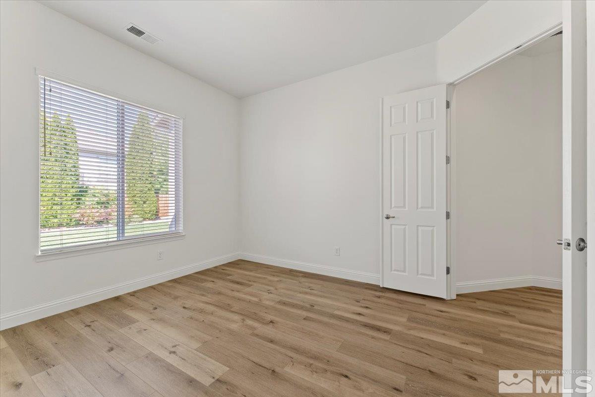 3259 Diamond Ridge Drive Reno, NV 89523 - Photo 22 of 40 a view of an empty room with wooden floor and a window