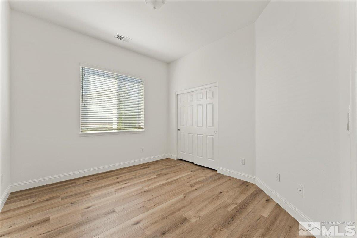 3259 Diamond Ridge Drive Reno, NV 89523 - Photo 23 of 40 an empty room with wooden floor and windows