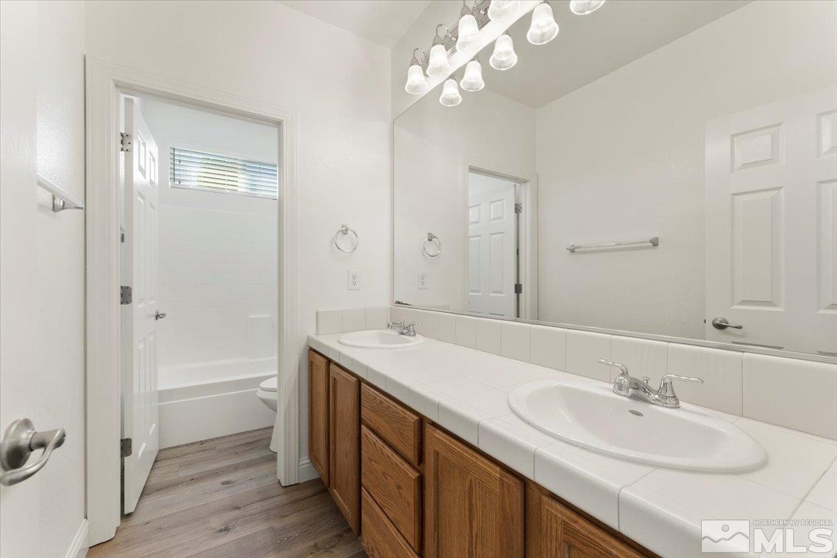 3259 Diamond Ridge Drive Reno, NV 89523 - Photo 24 of 40 a bathroom with a sink a vanity and a mirror