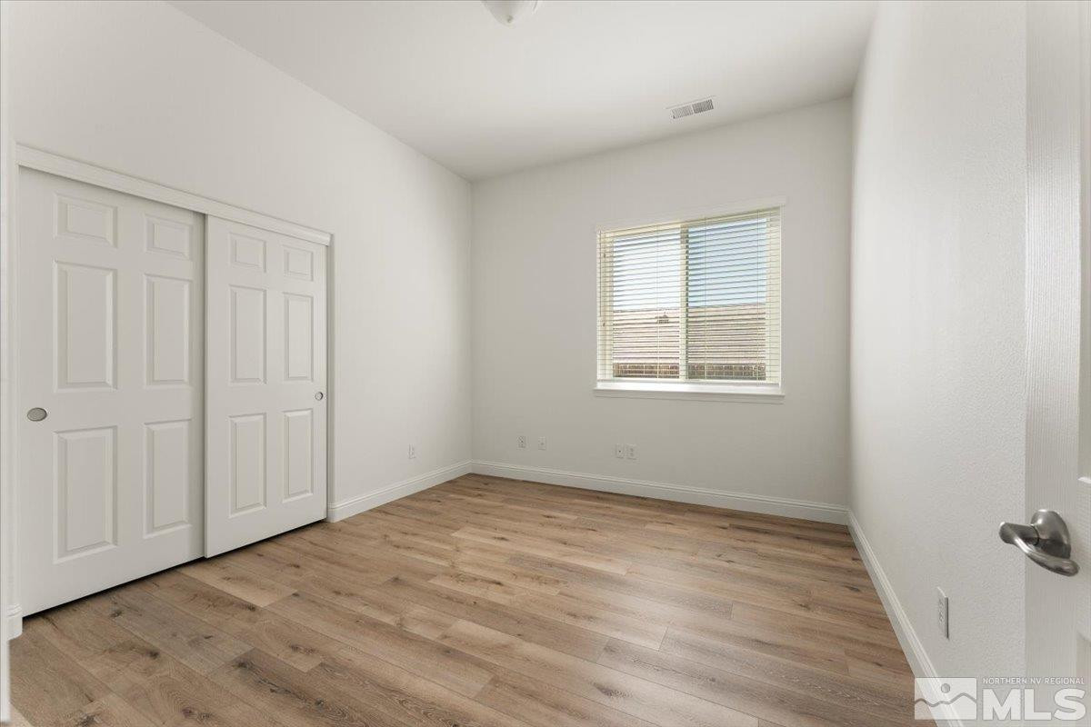 3259 Diamond Ridge Drive Reno, NV 89523 - Photo 25 of 40 an empty room with wooden floor and windows