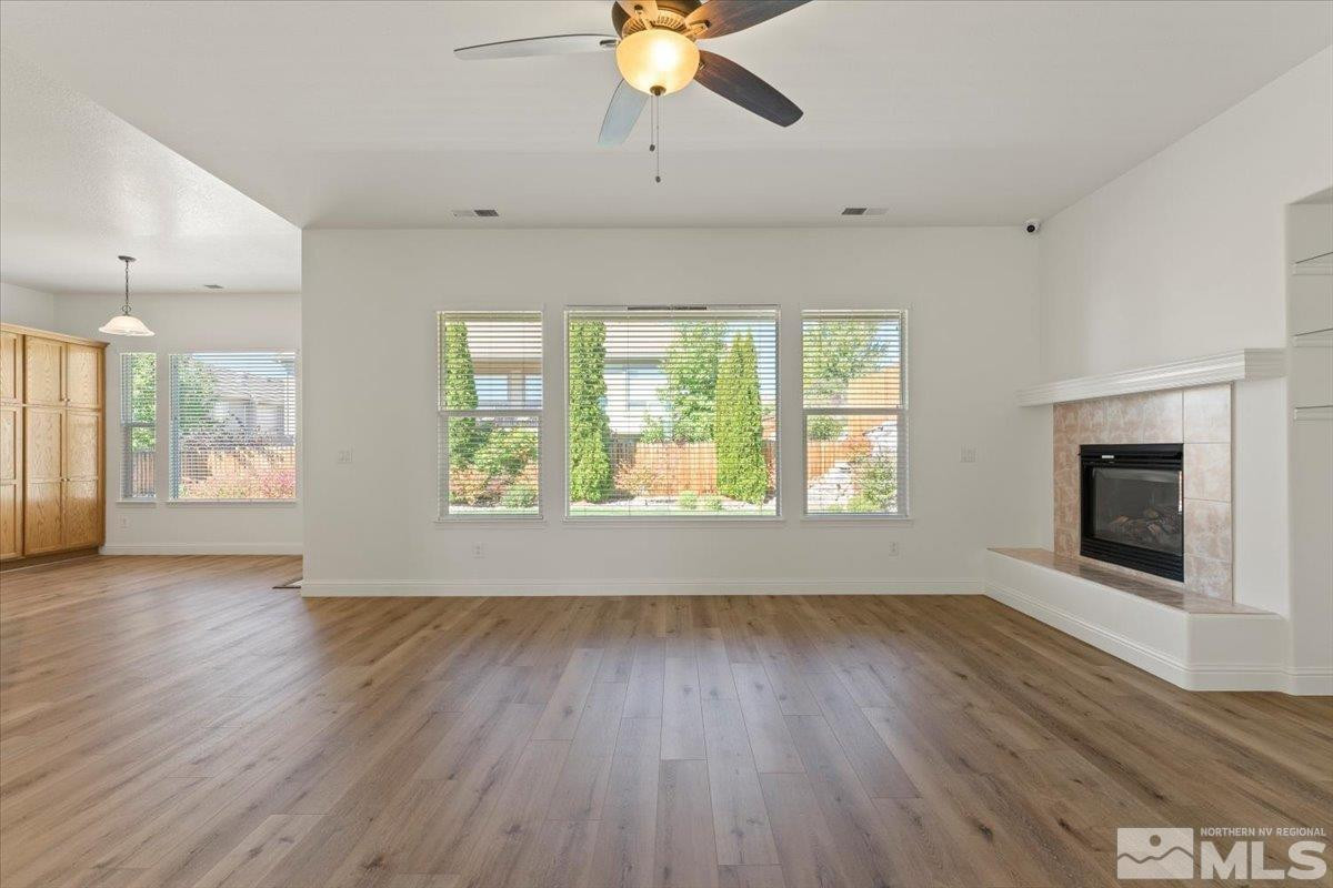 3259 Diamond Ridge Drive Reno, NV 89523 - Photo 7 of 40 a view of an empty room with wooden floor and a window