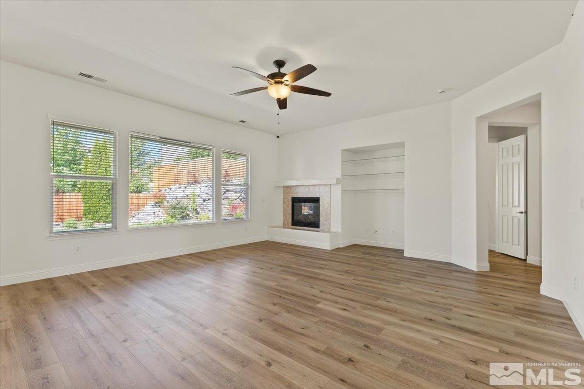 3259 Diamond Ridge Drive Reno, NV 89523 - Photo 8 of 40 a view of empty room with wooden floor and fan