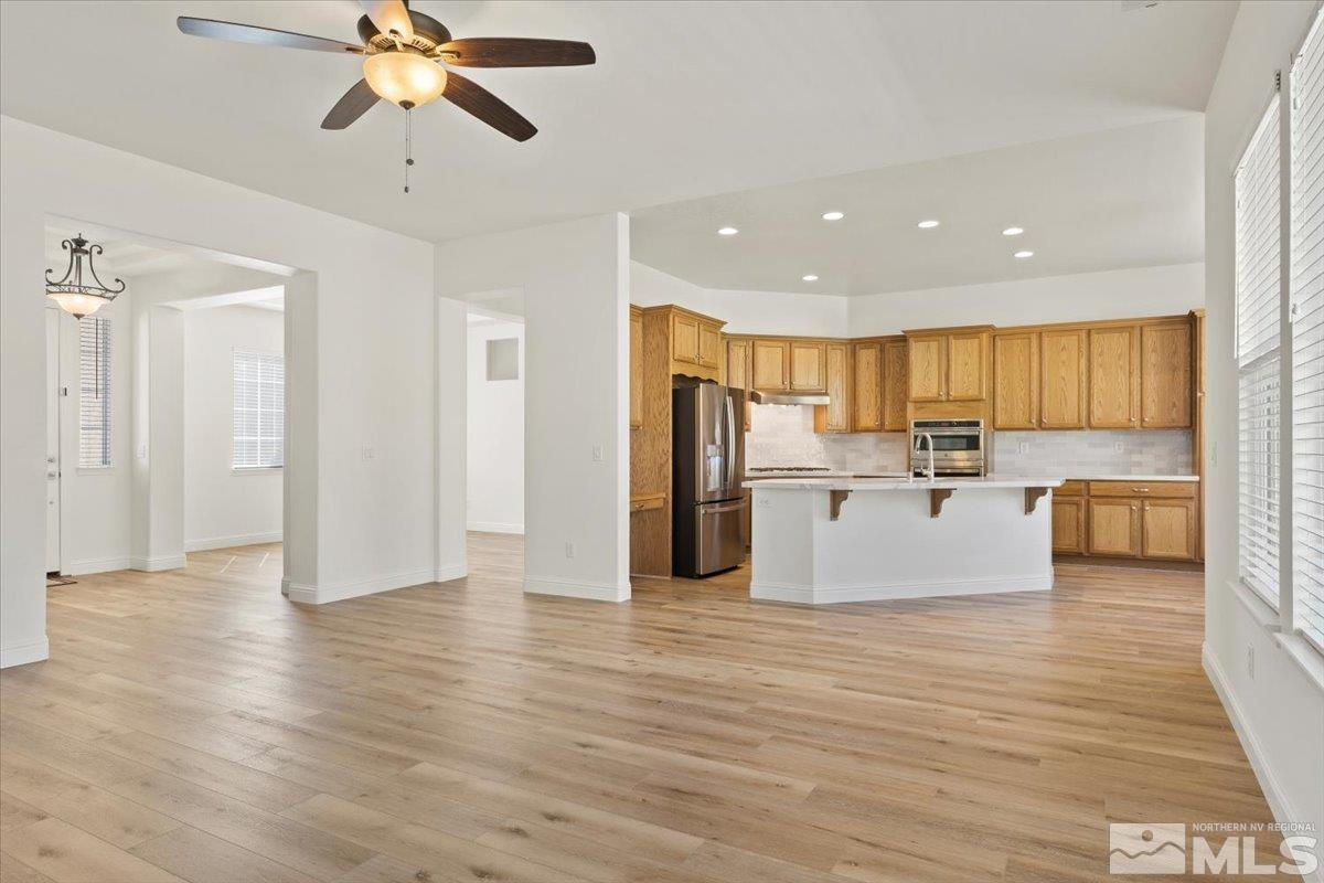 3259 Diamond Ridge Drive Reno, NV 89523 - Photo 10 of 40 a view of a kitchen with kitchen island wooden floor stainless steel appliances and cabinets
