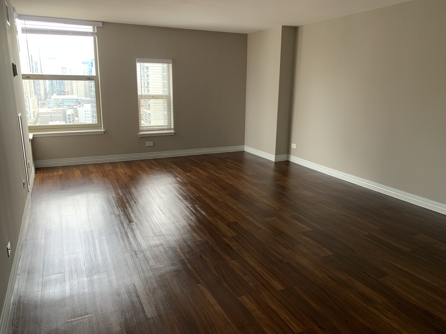 100 West Chestnut Street, Unit 3008 Chicago, IL 60610 - Photo 4 of 14 an empty room with wooden floor and windows