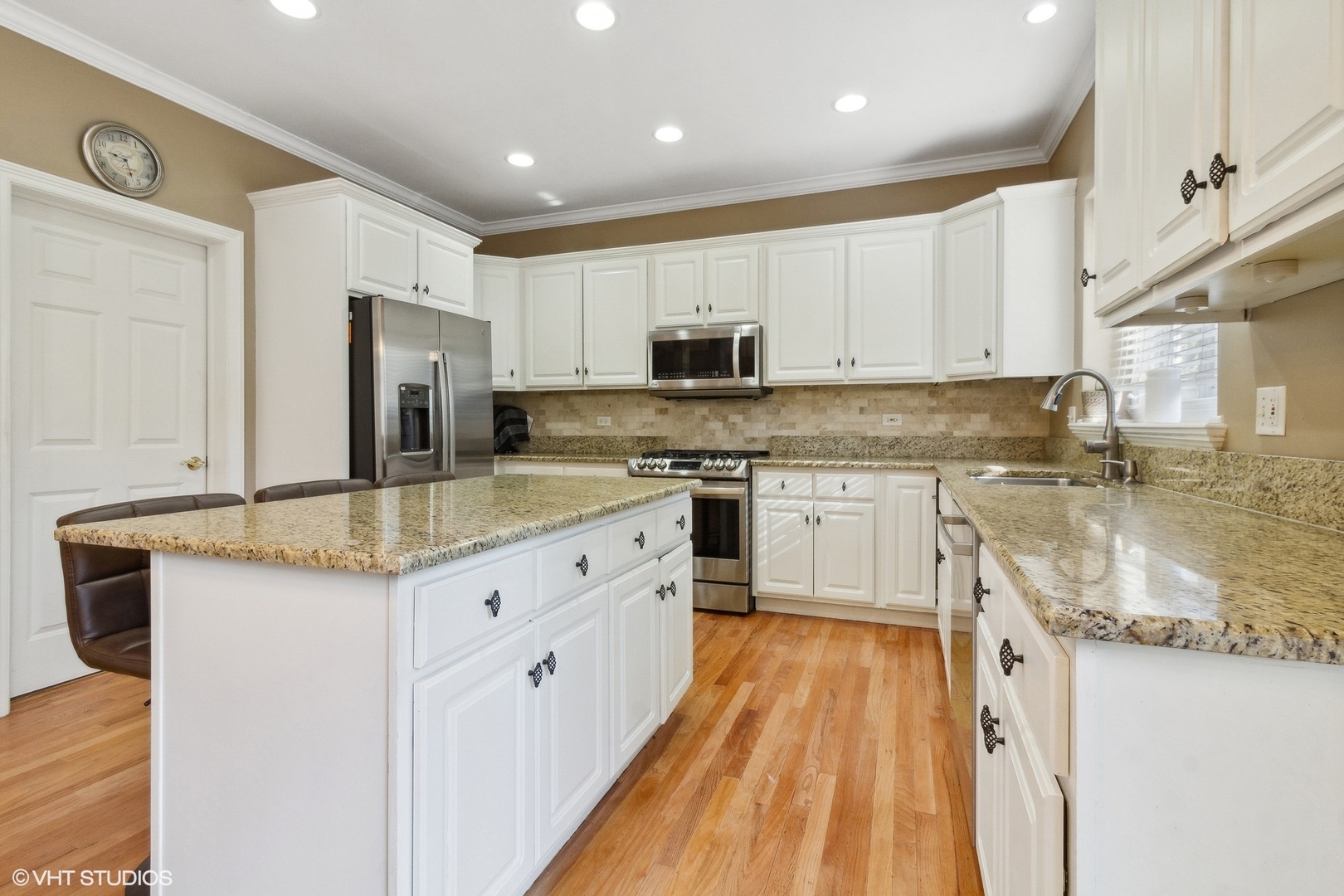 13765 Capista Drive Plainfield, IL 60544 - Photo 5 of 19 a kitchen with granite countertop a sink stove cabinets and refrigerator