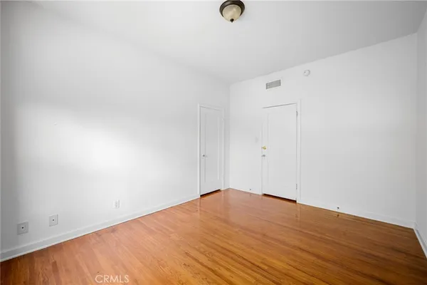 an empty room with wooden floor