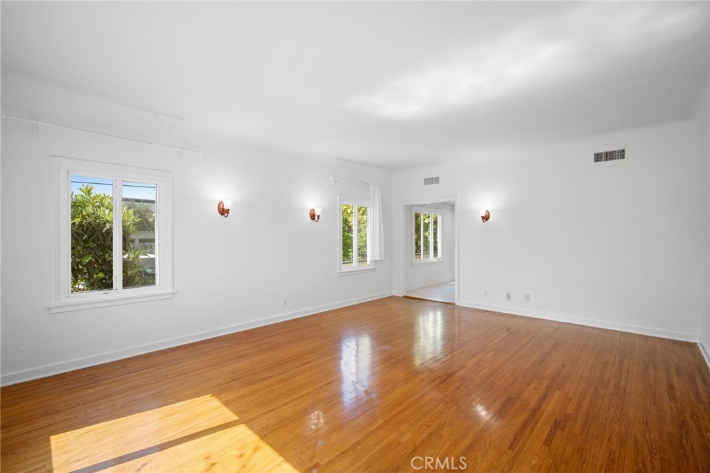 216 East Windsor Road, Unit 2 Glendale, CA 91205 - Photo 4 of 20 an empty room with wooden floor and windows