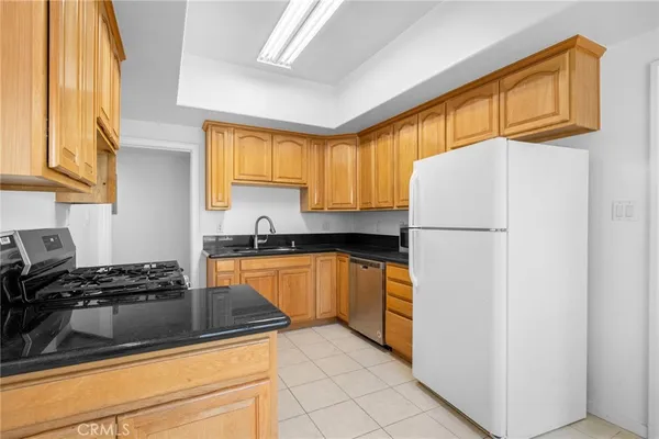 a kitchen with a refrigerator and a sink