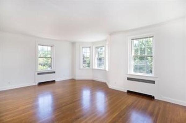 92 Beacon Street, Unit 41 Boston, MA 02108 - Photo 1 of 8 an empty room with wooden floor and windows