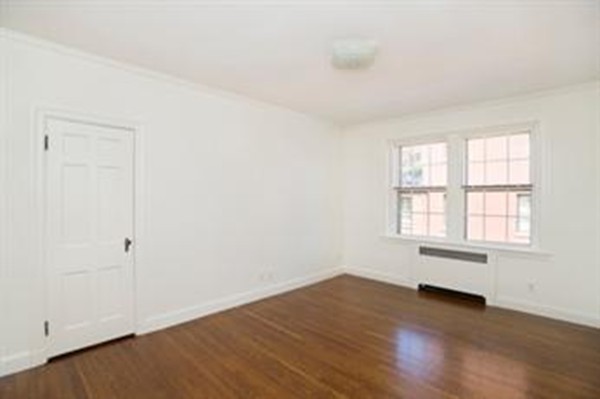 92 Beacon Street, Unit 41 Boston, MA 02108 - Photo 2 of 8 an empty room with wooden floor and windows