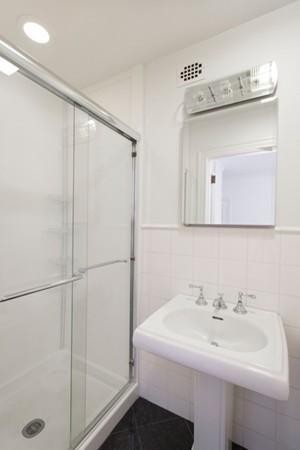 92 Beacon Street, Unit 41 Boston, MA 02108 - Photo 5 of 8 a bathroom with a sink a mirror a vanity and shower