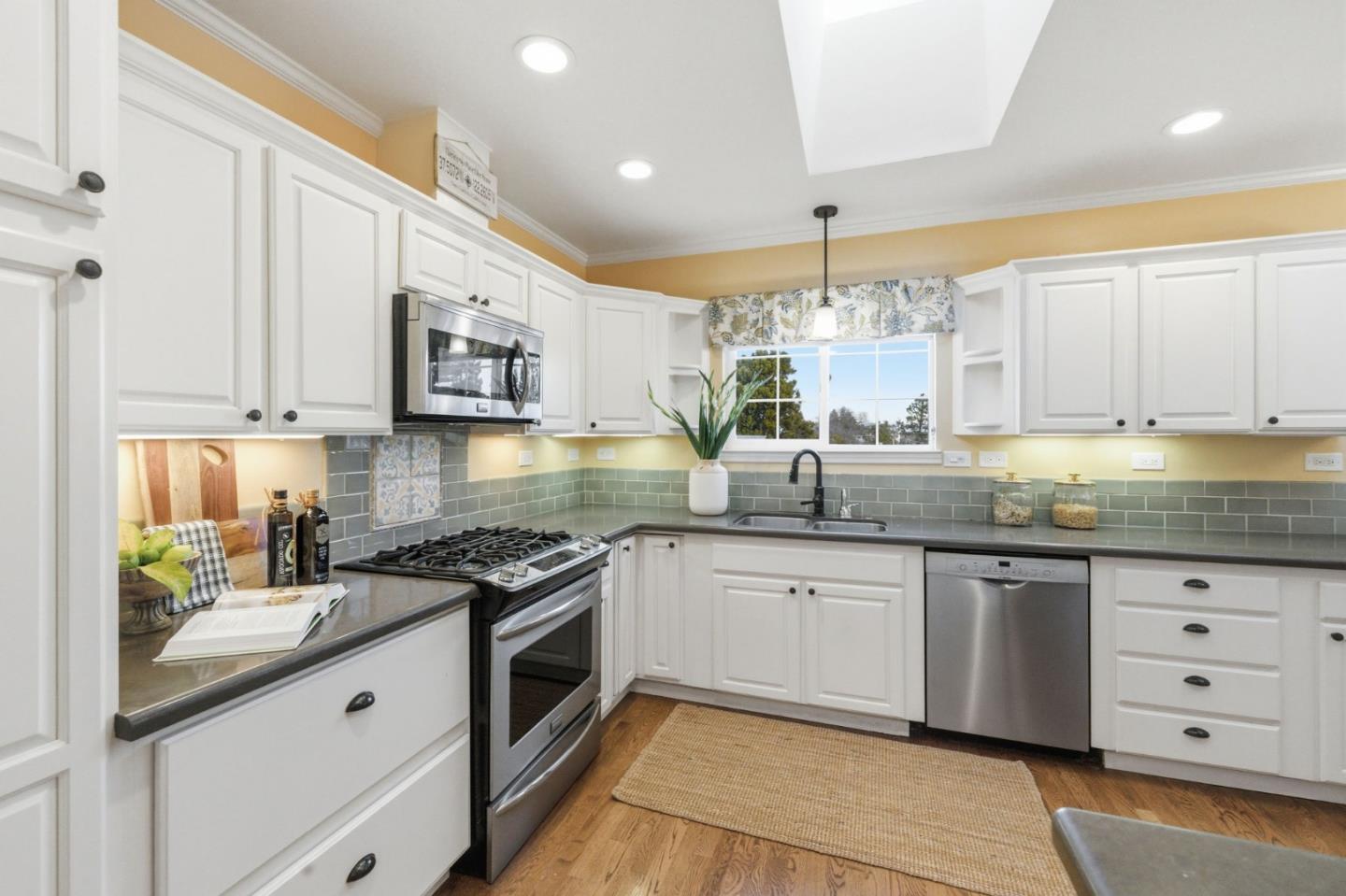 418 Ridge Road San Carlos, CA 94070 - Photo 21 of 64 a kitchen with stainless steel appliances granite countertop a stove sink and cabinets