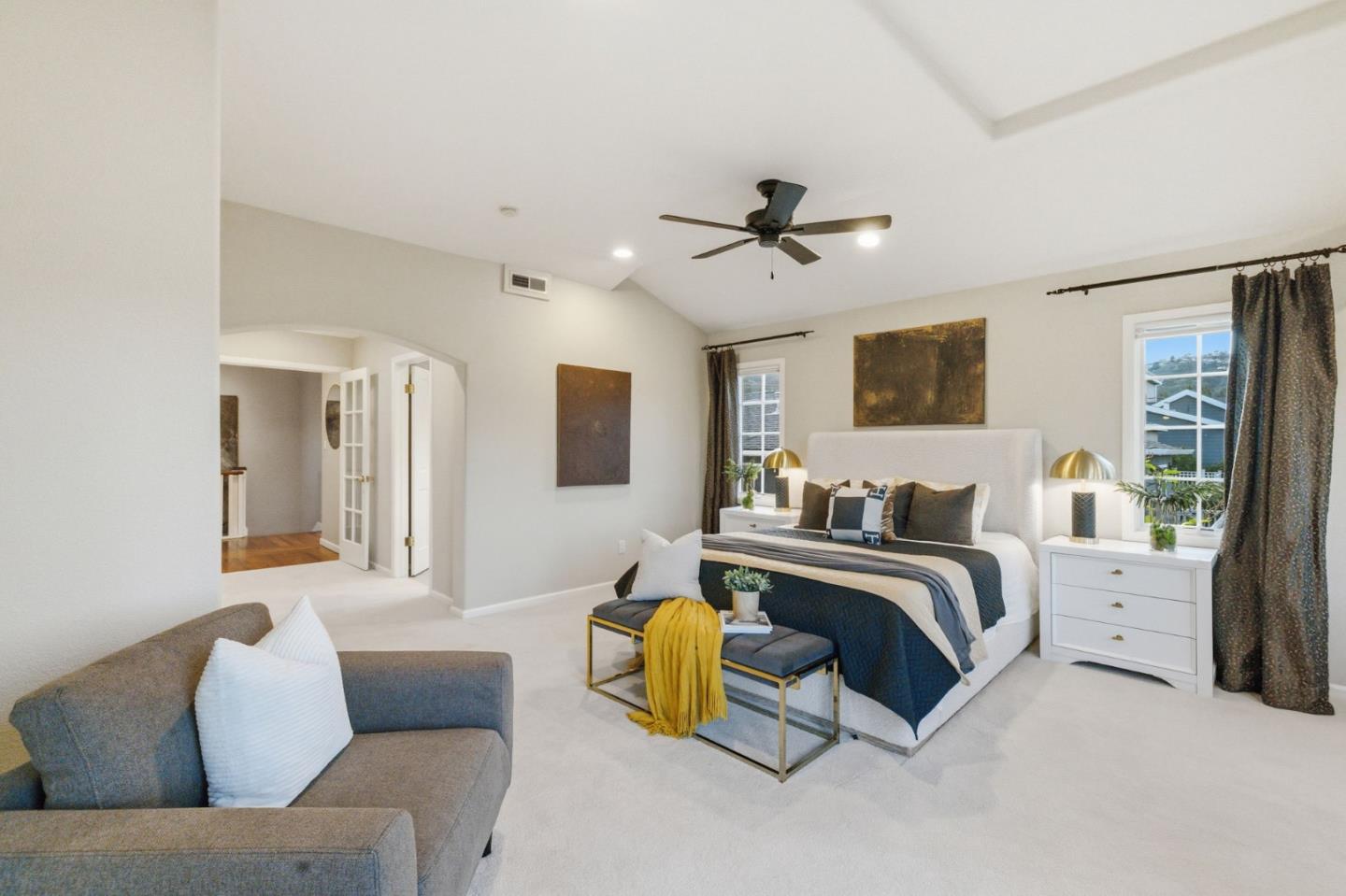 418 Ridge Road San Carlos, CA 94070 - Photo 23 of 64 a spacious bedroom with a bed a couch and a chandelier