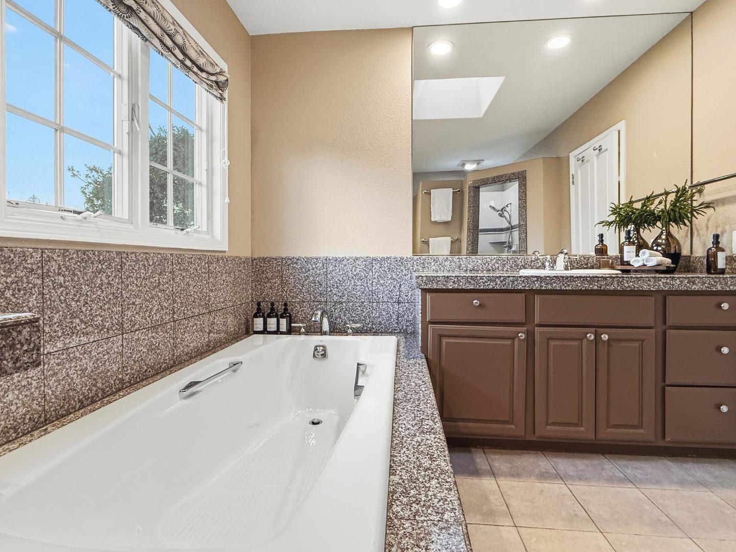 418 Ridge Road San Carlos, CA 94070 - Photo 27 of 64 a bathroom with a granite countertop sink and a bathtub