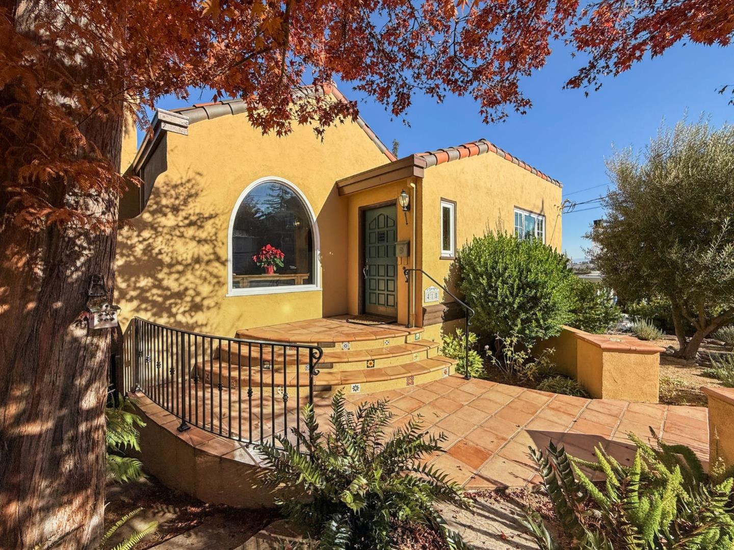 418 Ridge Road San Carlos, CA 94070 - Photo 5 of 64 a view of a house with a large tree and wooden fence