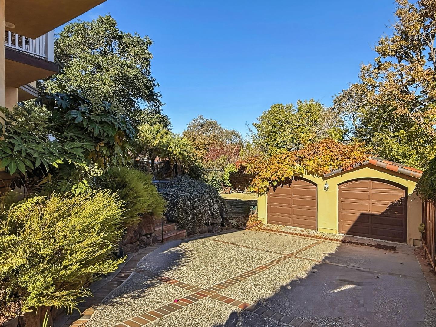 418 Ridge Road San Carlos, CA 94070 - Photo 59 of 64 a front view of a house with a yard and garage