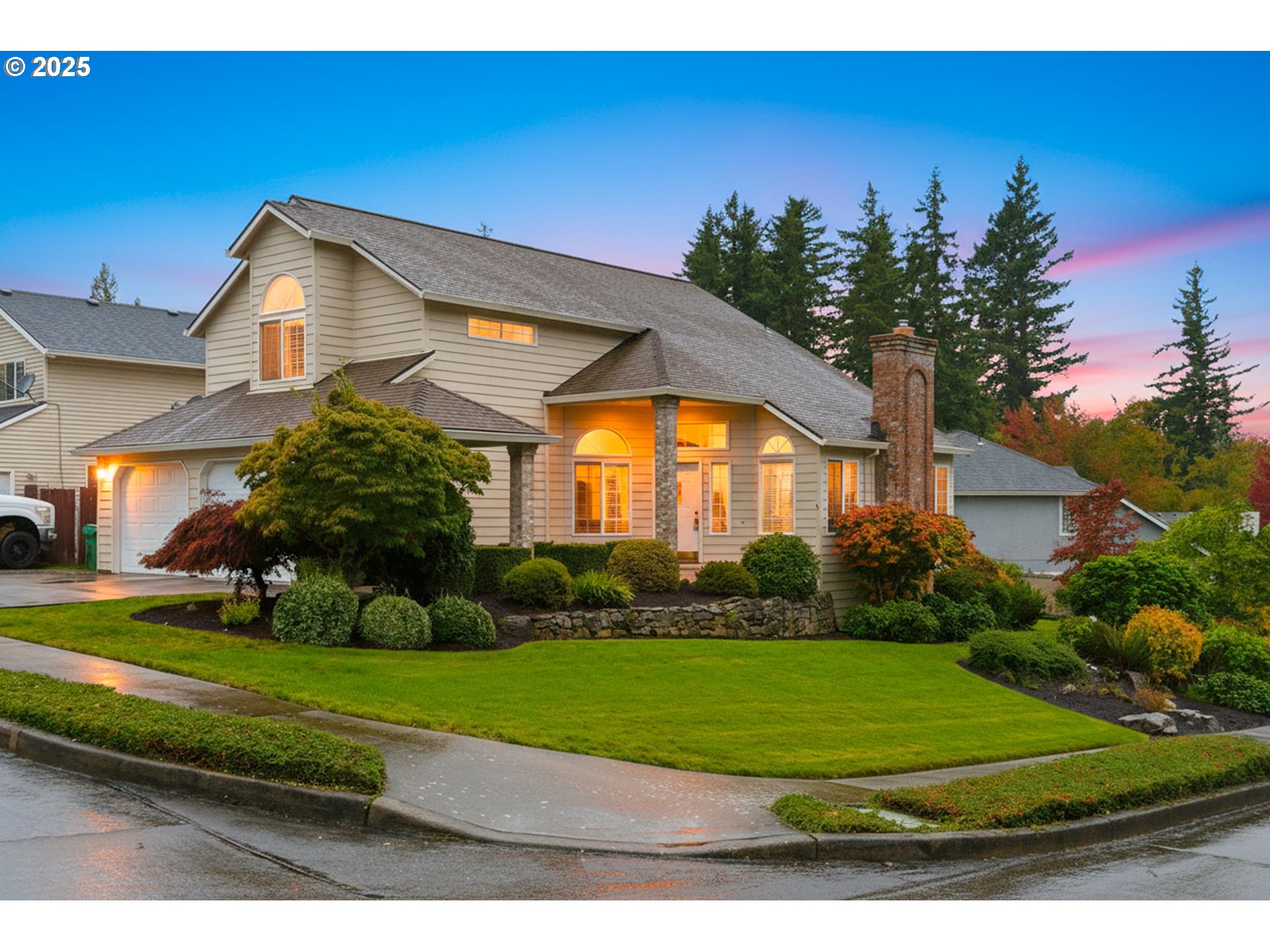 a view of a big house with a big yard and potted plants