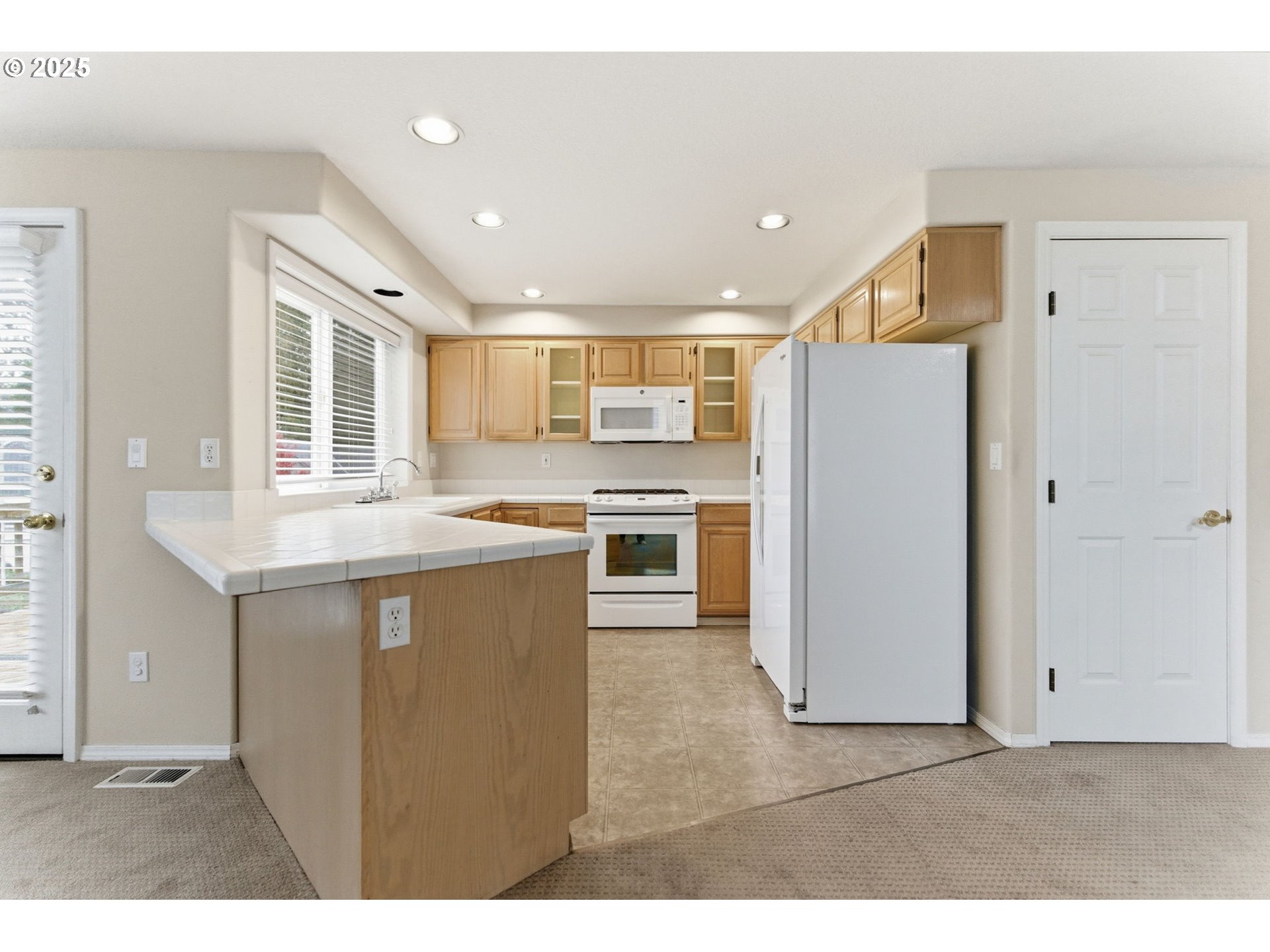 4753 Southeast 14th Street Gresham, OR 97080 - Photo 18 of 48 a kitchen with stainless steel appliances granite countertop a refrigerator a sink a stove and oven