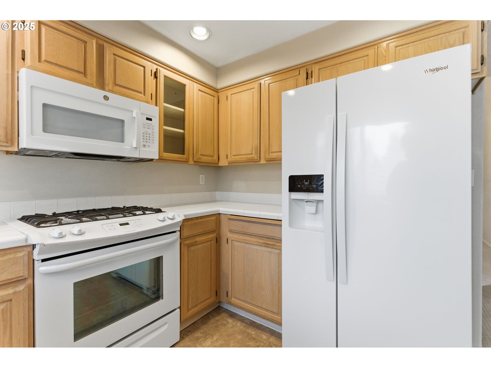 4753 Southeast 14th Street Gresham, OR 97080 - Photo 20 of 48 a kitchen with stainless steel appliances white cabinets and a stove top oven