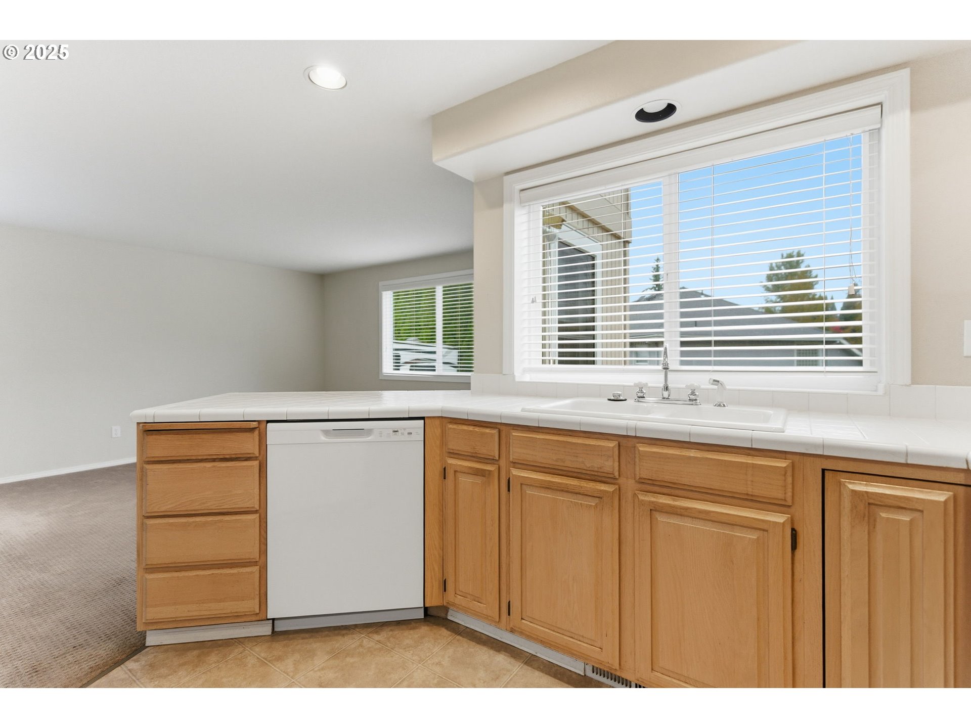4753 Southeast 14th Street Gresham, OR 97080 - Photo 22 of 48 a kitchen with a window wooden floor and cabinets