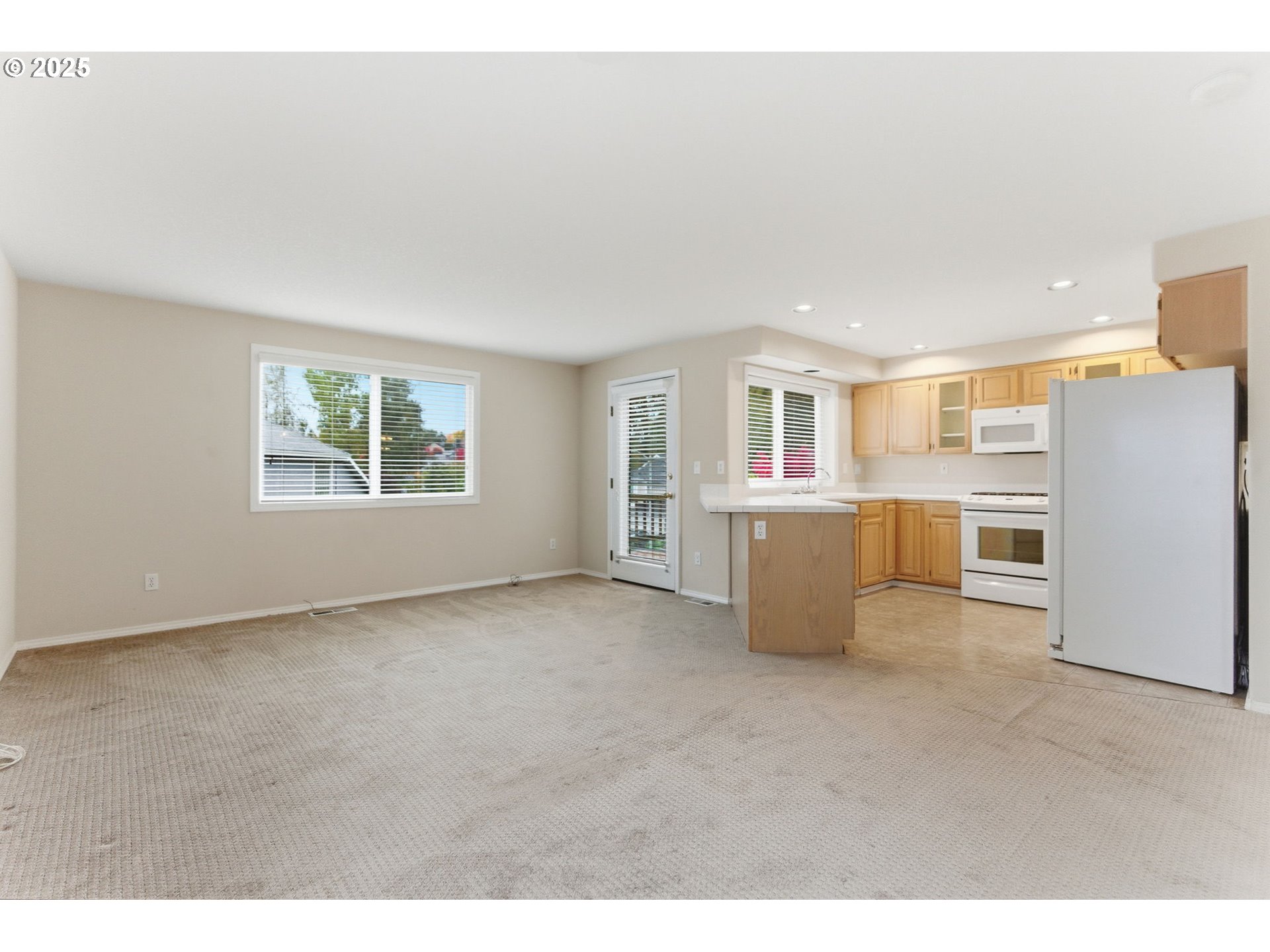 4753 Southeast 14th Street Gresham, OR 97080 - Photo 23 of 48 a view of a kitchen with a refrigerator a sink and dishwasher