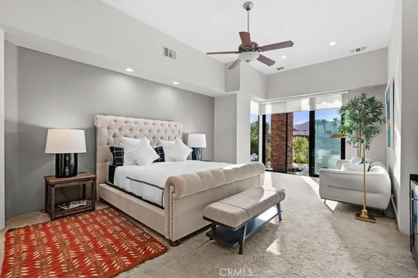 a bedroom with a bed and a large window