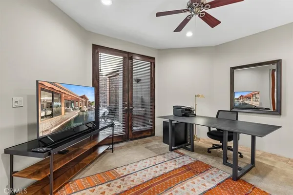 a living room with patio furniture and a table