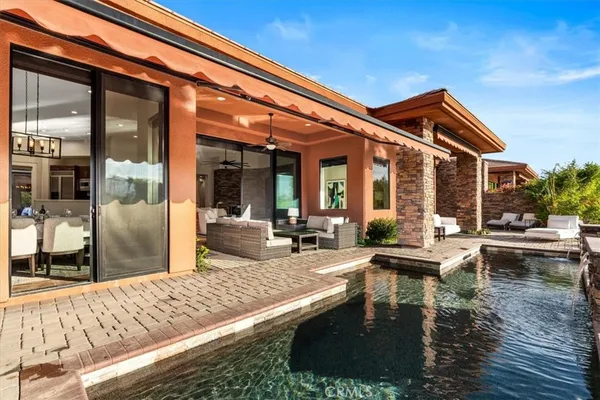 a view of swimming pool with outdoor seating