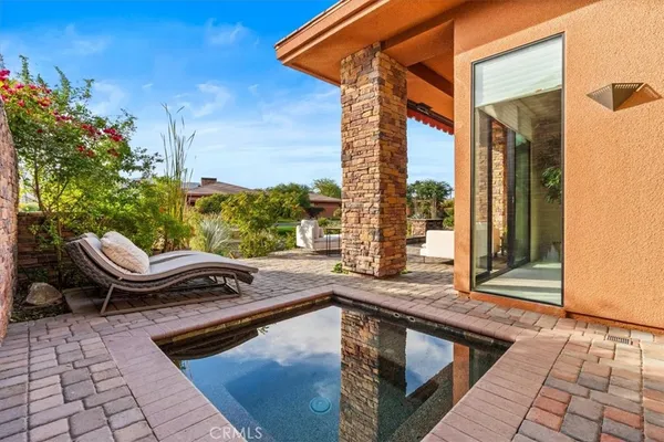 a view of swimming pool with outdoor seating
